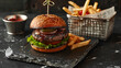 Luxurious Cheeseburger on Brioche Bun with Crispy Fries in Moody Tavern Setting,Hamburger whit meat, lettuce, tomato and and French fries on wooden table
