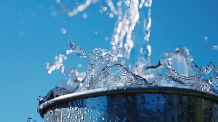 Wall Mural - Pouring water splashes into the bucket.