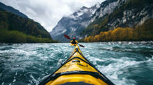 Rear View Of A Man Floating In A Kayak On A Fast, Stormy Mountain River