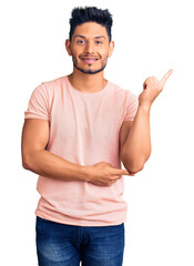 Wall Mural - Handsome latin american young man wearing casual clothes smiling happy pointing with hand and finger to the side