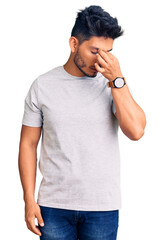 Poster - Handsome latin american young man wearing casual tshirt tired rubbing nose and eyes feeling fatigue and headache. stress and frustration concept.