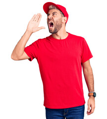 Wall Mural - Young handsome blond man wearing t-shirt and cap shouting and screaming loud to side with hand on mouth. communication concept.