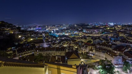 Wall Mural - Lisbon after sunset aerial panoramic view of city centre with roofs at autumn day to night transition timelapse, Portugal. Top view from Sophia de Mello Breyner Andresen viewpoint. Lights turning on