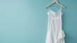 Mockup of white women cotton dress on blue background. Layout mock up ready for your design preview.