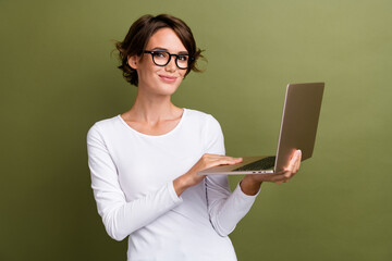 Canvas Print - Photo portrait of attractive young woman hold notebook working remotely wear trendy white clothes isolated on khaki color background