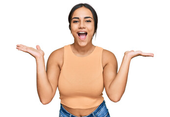 Wall Mural - Young brunette woman wearing casual clothes celebrating crazy and amazed for success with arms raised and open eyes screaming excited. winner concept