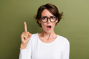 Sticker - Photo portrait of pretty young girl point up concerned offended wear trendy white clothes isolated on khaki color background