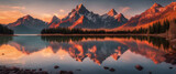 Fototapeta  - A breathtaking sunrise over the mountains near Lake captures the serene beauty of nature with warm hues in the sky and reflections on the water. The silhouette of mountain peaks adds to its grandeur.