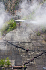 Wall Mural - Metal steps leading vertically up the wall of a huge hydrolectric dam in Japan