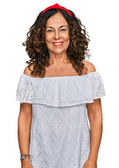 Sticker - Middle age hispanic woman wearing casual clothes looking positive and happy standing and smiling with a confident smile showing teeth