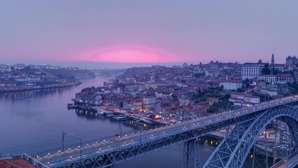 Wall Mural - Day to night transition aerial panoramic view of the historic city of Porto, Portugal timelapse with the Dom Luiz bridge. Colorful sky after sunset