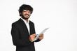 Handsome Indian businessman in black suit checking the quality with clipboard isolated over white background. Hindu manager revising, taking notes , doing paperwork