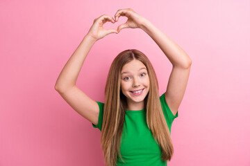 Canvas Print - Photo portrait of pretty teenager girl raise hands show heart gesture dressed stylish green outfit isolated on pink color background