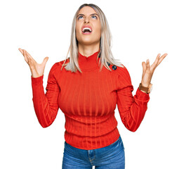 Sticker - Beautiful blonde woman wearing casual clothes crazy and mad shouting and yelling with aggressive expression and arms raised. frustration concept.