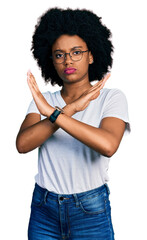 Sticker - Young african american woman wearing casual white t shirt rejection expression crossing arms doing negative sign, angry face