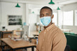 Young African businessman wearing a protective face mask at the office