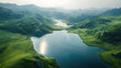 An aerial view of a tranquil lake nestled amidst rolling hills
