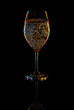 White Wine Glasse with sparkling water over Black Background.