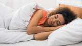 Fototapeta  - Woman sleeping, lying in bed comfortably and blissfully