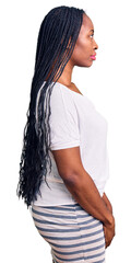 Sticker - Young african american woman wearing casual clothes looking to side, relax profile pose with natural face with confident smile.