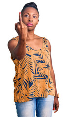 Wall Mural - Young african american woman wearing casual clothes showing middle finger, impolite and rude fuck off expression