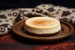 Refined cheesecake in a clay dish against a coffee sack fabric background
