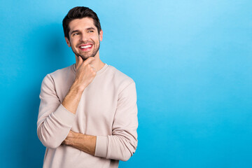 Poster - Photo of intelligent guy stylish hairstyle dressed white pullover look empty space think business idea isolated on blue color background