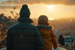 Two in winter attire, look out at sunrise, cityscape beneath them, cold day’s dawning light engulfs. Pair in puff jackets face daybreak, silhouetted against urban horizon, morning chill lingering.