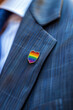 © Studio F. - Close up enamel LGBTQ+ lapel pin on a business suit