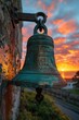 Brass Church Bell Silhouetted Against the Sunset The bell merges with the dusk