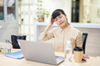 © Lili.Q - White-collar worker sitting on an office chair and turning his neck to move his body