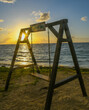 A swing on the beach at sunrise, coconut bay, St. Lucia