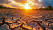 Sun over a parched landscape, cracks forming in the ground from the dryness