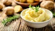 Creamy Mashed Potatoes in a White Bowl on Rustic Wooden Table. Perfect Vegetarian Dish for Healthy Cooking and Eating