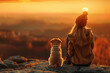 A young woman and her faithful dog sit side by side on a mountain, basking in the warm glow of a vibrant sunset.Personal reflection, meditation, mental and spiritual well-being