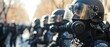 Riot police in full gear confront a group of protesters during a demonstration. Concept Conflict Photography, Protest Coverage, Law Enforcement Interactions, Public Demonstrations, Civil Unrest