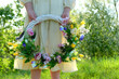 decorative Spring wreath in hands girl, natural background. symbol of Beltane holiday. festive decor for spring or summer