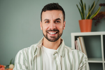 close up portrait of one handsome guy with perfect white teeth smiling at home. front view of young 