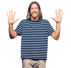 Wall Mural - Handsome caucasian man with long hair wearing casual striped t-shirt showing and pointing up with fingers number ten while smiling confident and happy.