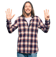 Sticker - Handsome caucasian man with long hair wearing hipster shirt showing and pointing up with fingers number eight while smiling confident and happy.