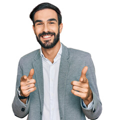 Canvas Print - Young hispanic man wearing business clothes pointing fingers to camera with happy and funny face. good energy and vibes.