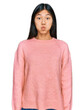 © Krakenimages.com - Beautiful young asian woman wearing casual winter sweater puffing cheeks with funny face. mouth inflated with air, crazy expression.