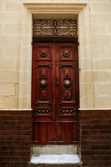 Wall Mural - Old wooden door with decorative elements in city