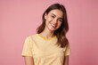 Portrait photo of attractive positive young girl wearing yellow striped t-shirt confident smile looking at you isolated on pink color background
