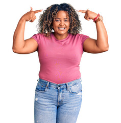 Wall Mural - Young african american plus size woman wearing casual clothes smiling pointing to head with both hands finger, great idea or thought, good memory