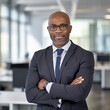 © mindstorm - lifestyle photo business man ceo standing in office arms crossed.
