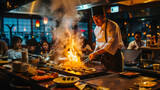 Fototapeta Las - teppanyaki_restaurant_with_its_cook_chief_cooking