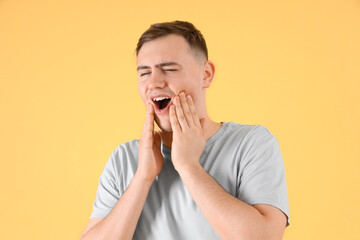 Sticker - Young man suffering from toothache on color background, closeup