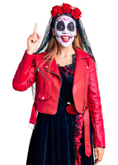 Poster - Woman wearing day of the dead costume over background pointing finger up with successful idea. exited and happy. number one.