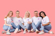© Pixel-Shot - People with lavender awareness ribbons sitting on pink background. World Cancer Day